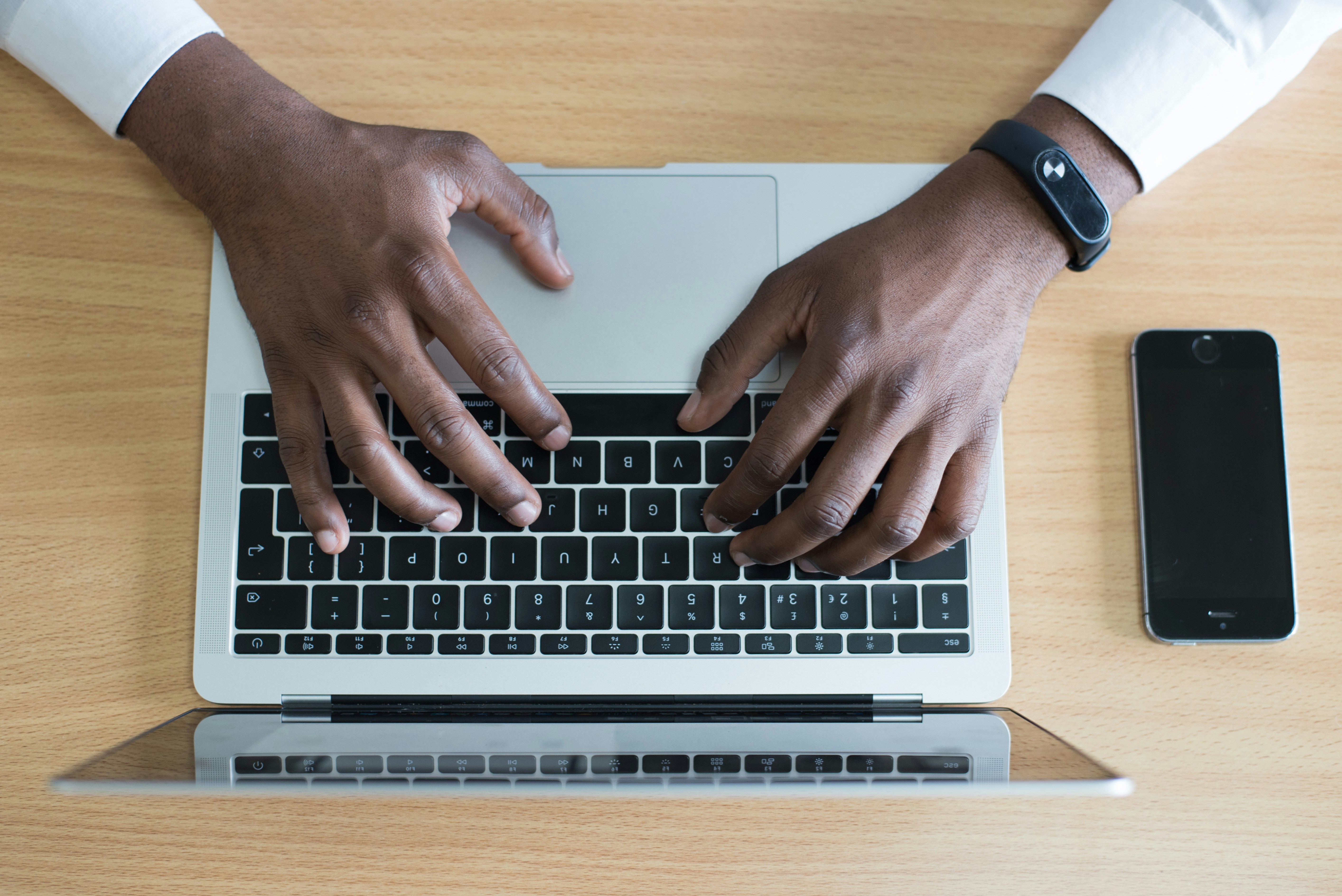 hands typing on a keyboard
